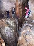 00395-1567 Crossing a deep chasm in Stonehorse Cave - photo by Garry K Smith